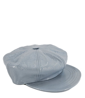 Structured newsboy cap crafted in textured material with panel stitching, a covered button top, and a short curved brim