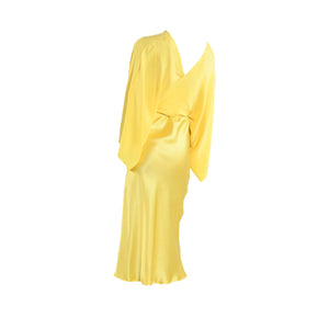 Yellow satin dress on a white background