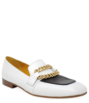 A leather loafer with a flat sole and rounded toe, featuring a contrasting vamp panel and dual chain accents across the upper. Designed by Madison in Beverly Hills and handcrafted in Italy.