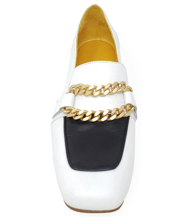 A leather loafer with a flat sole and rounded toe, featuring a contrasting vamp panel and dual chain accents across the upper. Designed by Madison in Beverly Hills and handcrafted in Italy.