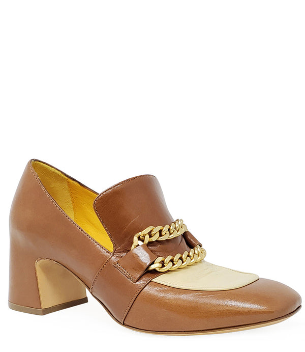 A leather heeled loafer with a block heel and rounded toe, featuring layered chain accents across the upper and a contrasting panel on the vamp. Designed by Madison in Beverly Hills and handcrafted in Italy.
