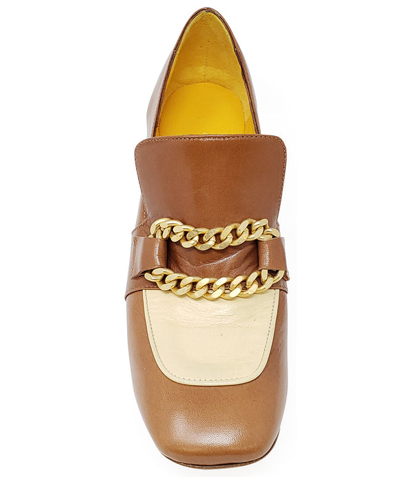 A leather heeled loafer with a block heel and rounded toe, featuring layered chain accents across the upper and a contrasting panel on the vamp. Designed by Madison in Beverly Hills and handcrafted in Italy.