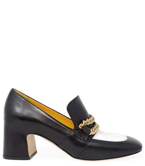 A leather heeled loafer with a block heel and rounded toe, featuring layered chain accents across the upper and a contrasting panel on the vamp. Designed by Madison in Beverly Hills and handcrafted in Italy.