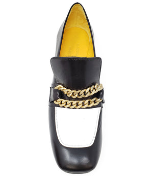 A leather heeled loafer with a block heel and rounded toe, featuring layered chain accents across the upper and a contrasting panel on the vamp. Designed by Madison in Beverly Hills and handcrafted in Italy.