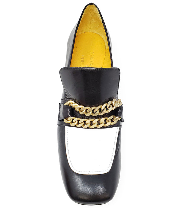 A leather heeled loafer with a block heel and rounded toe, featuring layered chain accents across the upper and a contrasting panel on the vamp. Designed by Madison in Beverly Hills and handcrafted in Italy.
