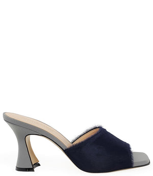 Handcrafted Italian mule with an open toe, flared heel, and a two-tone design. Features a wide vamp strap and cushioned insole for added comfort. Shown from multiple angles against a clean background