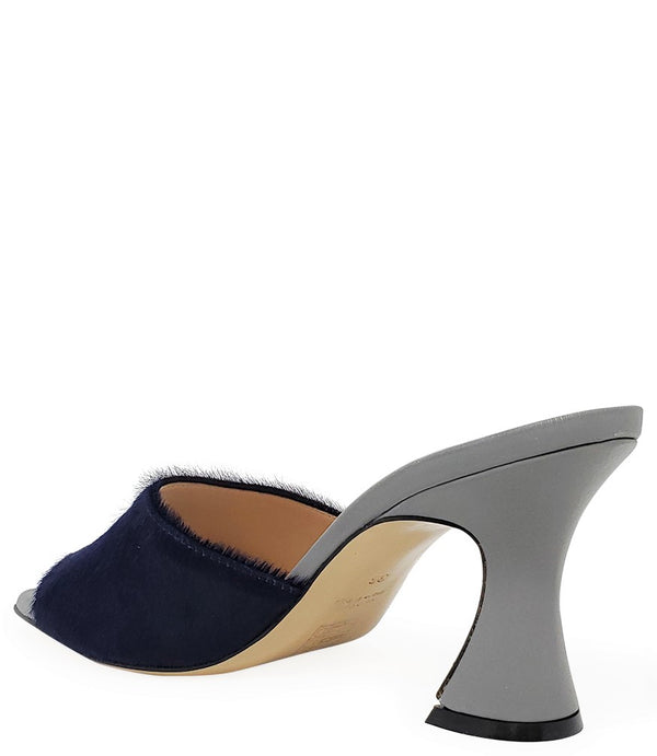 Handcrafted Italian mule with an open toe, flared heel, and a two-tone design. Features a wide vamp strap and cushioned insole for added comfort. Shown from multiple angles against a clean background