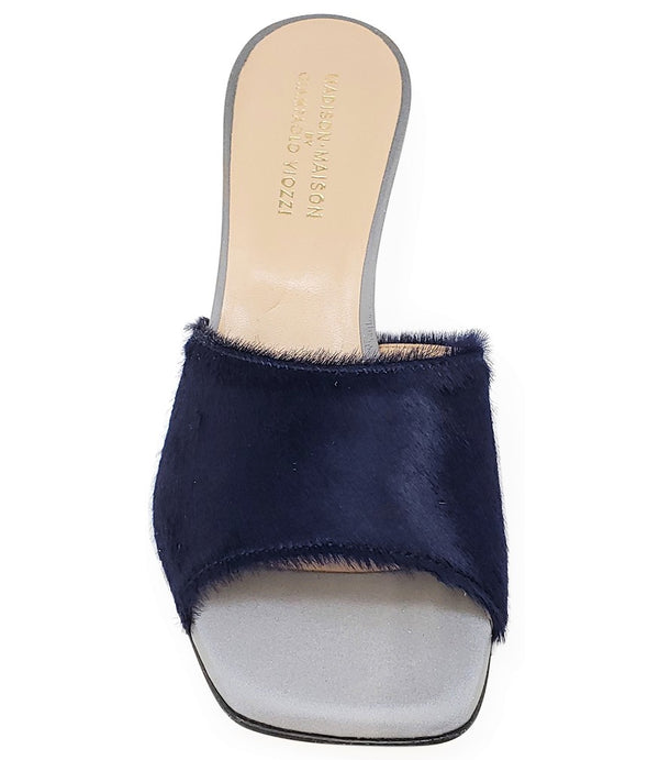 Handcrafted Italian mule with an open toe, flared heel, and a two-tone design. Features a wide vamp strap and cushioned insole for added comfort. Shown from multiple angles against a clean background