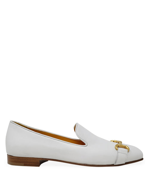 leather loafer with a rounded toe and flat sole, featuring a metal horsebit-style detail across the front. Designed by Madison in Beverly Hills and handcrafted in Italy.