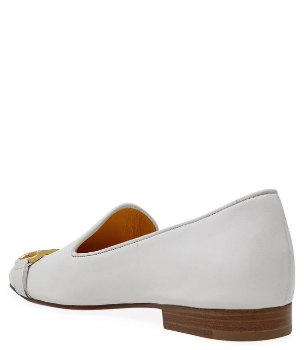 leather loafer with a rounded toe and flat sole, featuring a metal horsebit-style detail across the front. Designed by Madison in Beverly Hills and handcrafted in Italy.