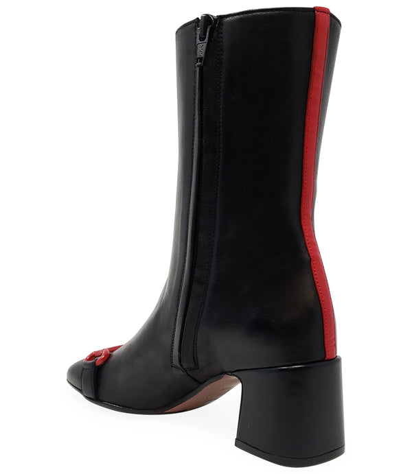 A mid-calf leather boot with a block heel and square toe, featuring a decorative metal accent across the toe. Designed by Madison in Beverly Hills and handcrafted in Italy.