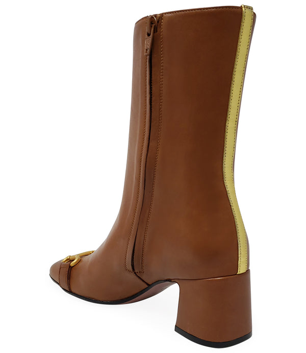 A mid-calf leather boot with a block heel and square toe, featuring a decorative metal accent across the toe. Designed by Madison in Beverly Hills and handcrafted in Italy.