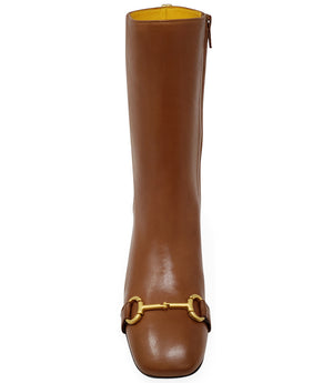 A mid-calf leather boot with a block heel and square toe, featuring a decorative metal accent across the toe. Designed by Madison in Beverly Hills and handcrafted in Italy.
