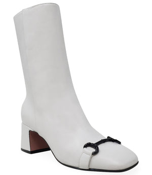 A mid-calf leather boot with a block heel and square toe, featuring a decorative metal accent across the toe. Designed by Madison in Beverly Hills and handcrafted in Italy.