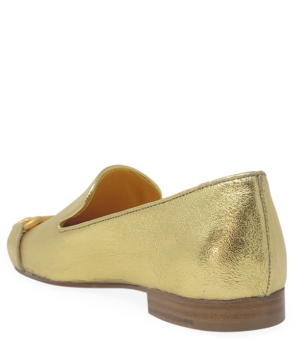 leather loafer with a rounded toe and flat sole, featuring a metal horsebit-style detail across the front. Designed by Madison in Beverly Hills and handcrafted in Italy.