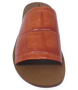 Handmade slide sandal crafted in Italy with a wide, textured band across the foot and a flat leather sole. Features a structured, embossed finish. Displayed from front and side angles against a clean background.