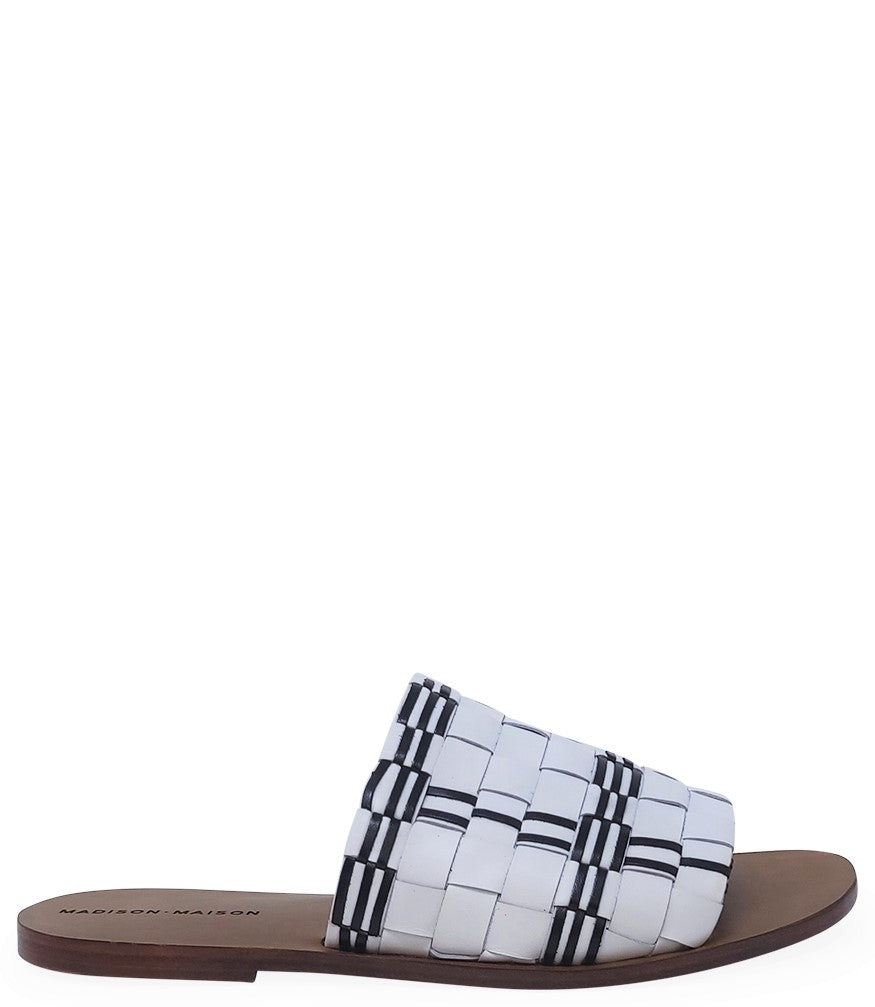Handmade Italian slide sandal featuring a wide woven upper with interlaced detailing and a flat leather sole. Shown from side and front angles against a clean background.