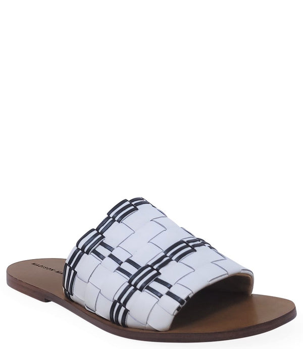 Handmade Italian slide sandal featuring a wide woven upper with interlaced detailing and a flat leather sole. Shown from side and front angles against a clean background.