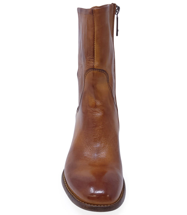 Mid-calf leather boot with rounded toe, block heel, and natural creasing for a worn-in effect. Features minimal seam detailing