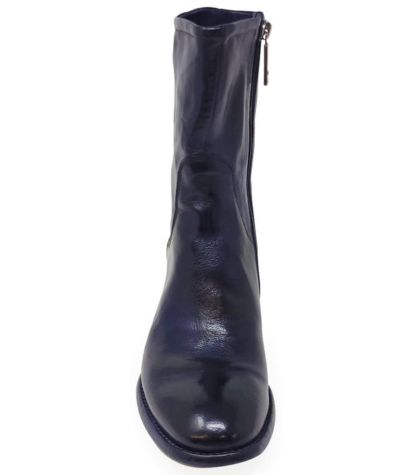 Mid-calf leather boot with rounded toe, block heel, and natural creasing for a worn-in effect. Features minimal seam detailing