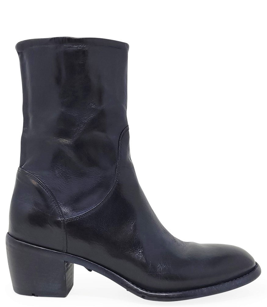Mid-calf leather boot with rounded toe, block heel, and natural creasing for a worn-in effect. Features minimal seam detailing
