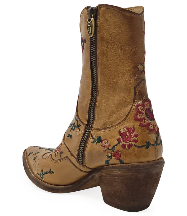 Western-style ankle boot featuring detailed floral embroidery, a pointed toe, side zipper, and angled block heel. Crafted with decorative stitching and a vintage finish.