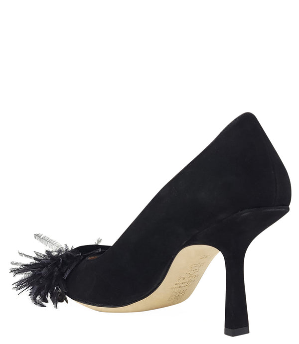 Pointed-toe pump crafted from soft suede with a mid-height stiletto heel, featuring a dramatic feather and velvet buckle embellishment across the toe. Designed with a leather-lined interior and a durable leather outsole for lasting comfort and support. El