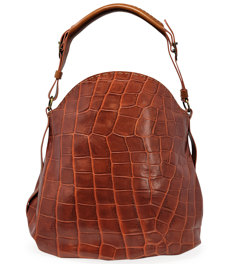 "Large hobo-style shoulder bag crafted from premium leather with an all-over crocodile-embossed texture. Features a wide, adjustable leather shoulder strap with metal hardware and an open top for easy access. Softly structured body designed for a relaxed