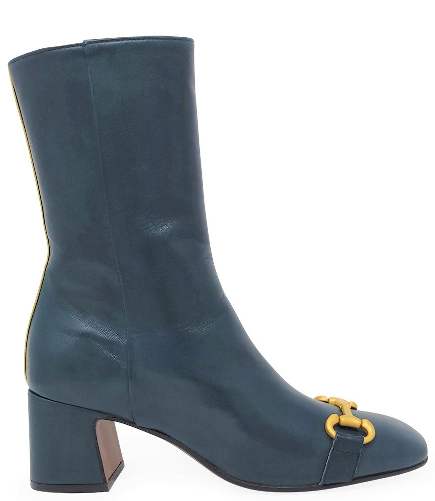 A mid-calf leather boot with a block heel and square toe, featuring a decorative metal accent across the toe. Designed by Madison in Beverly Hills and handcrafted in Italy.