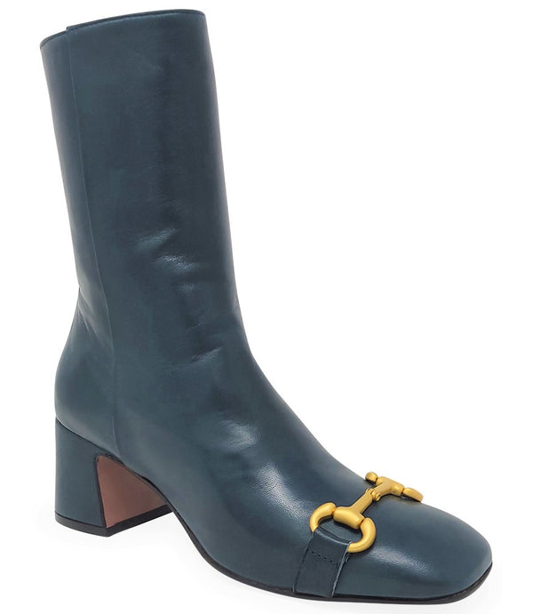 A mid-calf leather boot with a block heel and square toe, featuring a decorative metal accent across the toe. Designed by Madison in Beverly Hills and handcrafted in Italy.