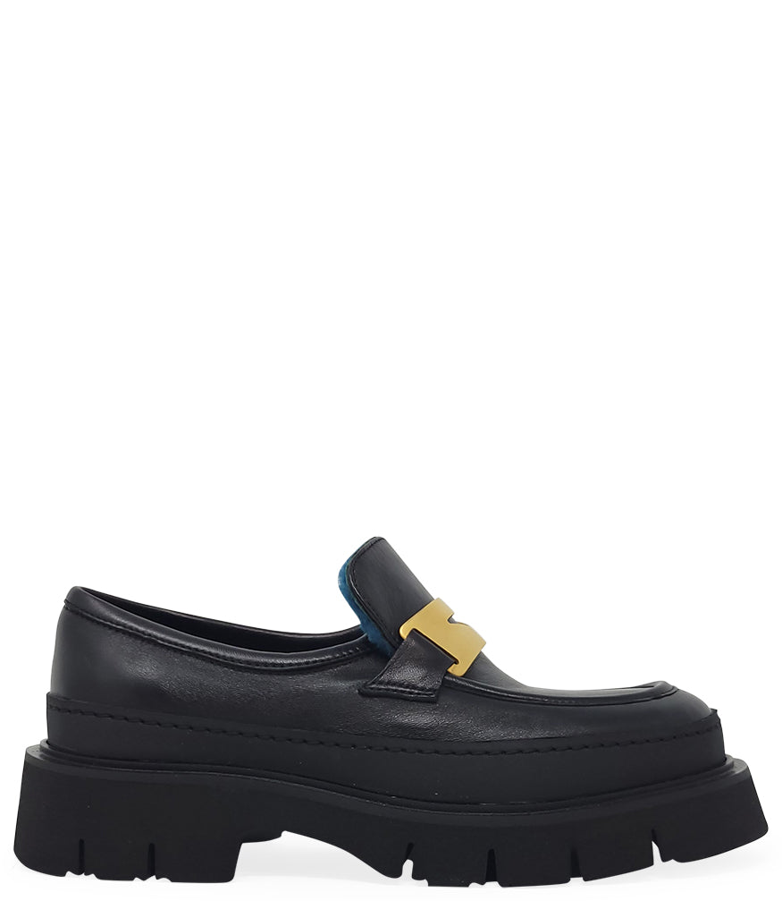 A leather loafer with an exaggerated lug sole and low-cut silhouette, featuring a wide strap with a geometric metal detail across the upper. Designed by Madison in Beverly Hills and handcrafted in Italy.
