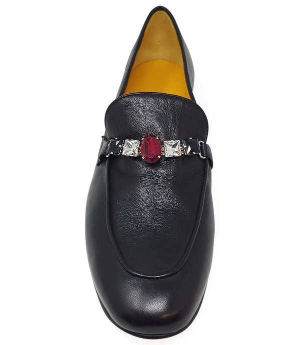 A leather loafer with a low stacked heel and rounded toe, featuring a decorative band adorned with faceted gemstone-style embellishments across the upper. Designed by Madison in Beverly Hills and handcrafted in Italy
