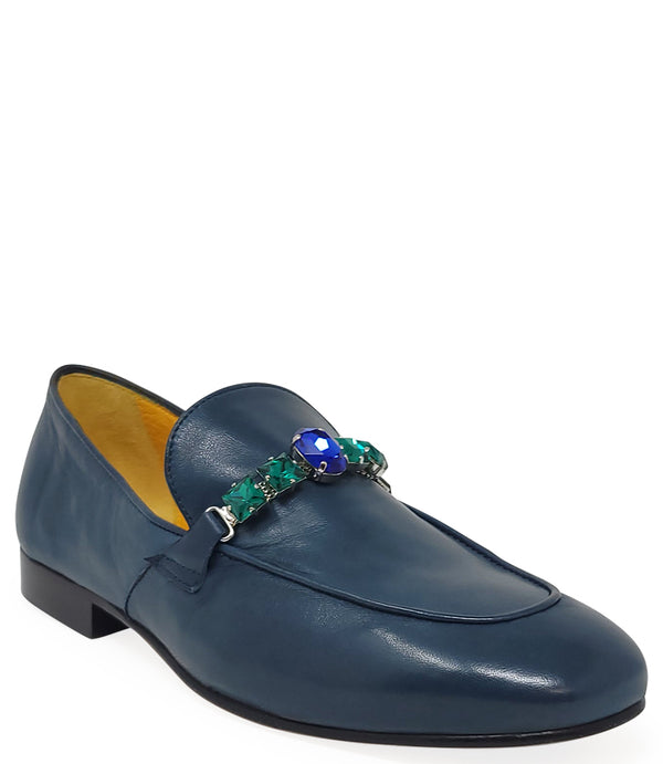 A leather loafer with a low stacked heel and rounded toe, featuring a decorative band adorned with faceted gemstone-style embellishments across the upper. Designed by Madison in Beverly Hills and handcrafted in Italy