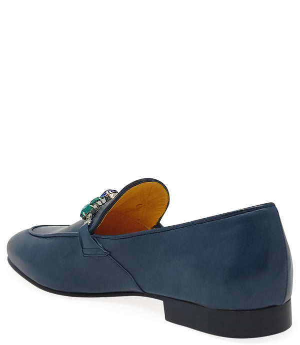 A leather loafer with a low stacked heel and rounded toe, featuring a decorative band adorned with faceted gemstone-style embellishments across the upper. Designed by Madison in Beverly Hills and handcrafted in Italy