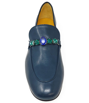 A leather loafer with a low stacked heel and rounded toe, featuring a decorative band adorned with faceted gemstone-style embellishments across the upper. Designed by Madison in Beverly Hills and handcrafted in Italy