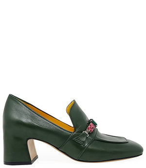 A leather heeled loafer with a block heel and square toe, featuring a decorative band with faceted gemstone-style embellishments across the upper. Designed by Madison in Beverly Hills and handcrafted in Italy.