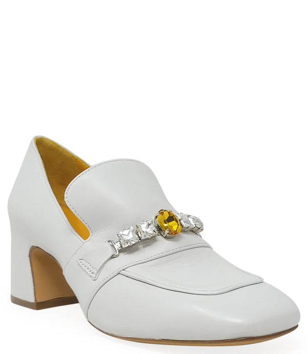 A leather heeled loafer with a block heel and square toe, featuring a decorative band with faceted gemstone-style embellishments across the upper. Designed by Madison in Beverly Hills and handcrafted in Italy.