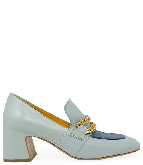 A leather heeled loafer with a block heel and rounded toe, featuring layered chain accents across the upper and a contrasting panel on the vamp. Designed by Madison in Beverly Hills and handcrafted in Italy.
