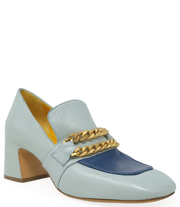 A leather heeled loafer with a block heel and rounded toe, featuring layered chain accents across the upper and a contrasting panel on the vamp. Designed by Madison in Beverly Hills and handcrafted in Italy.