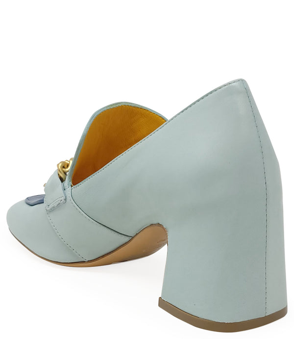 A leather heeled loafer with a block heel and rounded toe, featuring layered chain accents across the upper and a contrasting panel on the vamp. Designed by Madison in Beverly Hills and handcrafted in Italy.