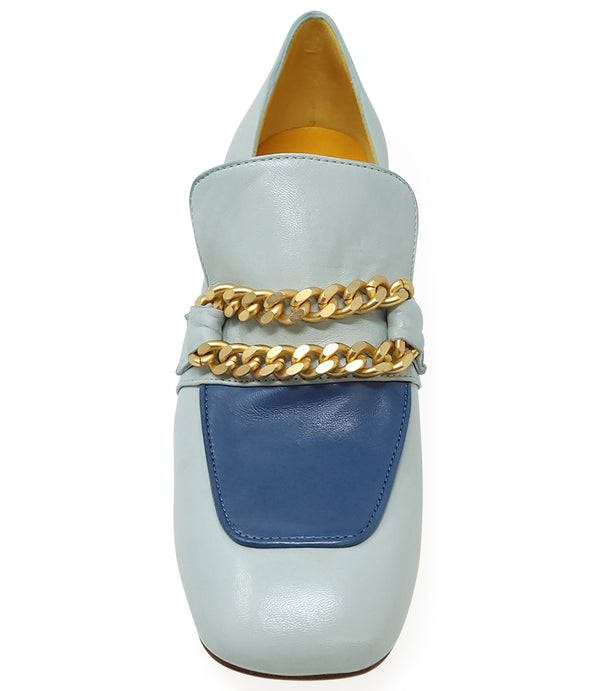 A leather heeled loafer with a block heel and rounded toe, featuring layered chain accents across the upper and a contrasting panel on the vamp. Designed by Madison in Beverly Hills and handcrafted in Italy.