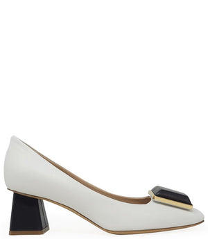 Elegant mid-heel pump handcrafted in Italy from 100% genuine leather, featuring a sculptural square embellishment on the toe and a block heel for all-day stability and style.