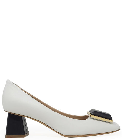 Elegant mid-heel pump handcrafted in Italy from 100% genuine leather, featuring a sculptural square embellishment on the toe and a block heel for all-day stability and style.