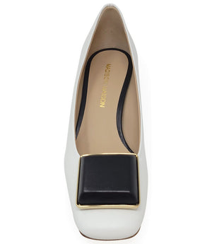 Elegant mid-heel pump handcrafted in Italy from 100% genuine leather, featuring a sculptural square embellishment on the toe and a block heel for all-day stability and style.