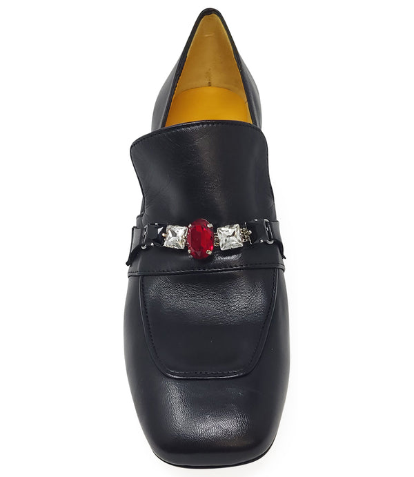 A leather heeled loafer with a block heel and square toe, featuring a decorative band with faceted gemstone-style embellishments across the upper. Designed by Madison in Beverly Hills and handcrafted in Italy.