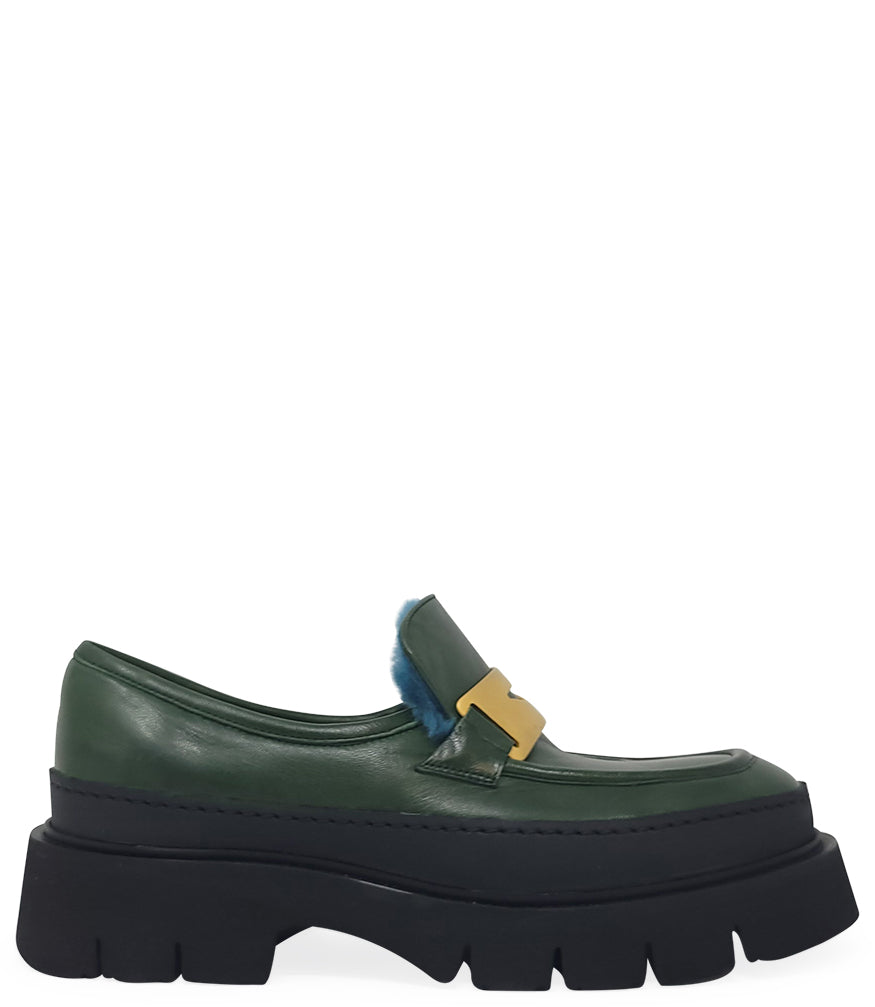 A leather loafer with an exaggerated lug sole and low-cut silhouette, featuring a wide strap with a geometric metal detail across the upper. Designed by Madison in Beverly Hills and handcrafted in Italy.