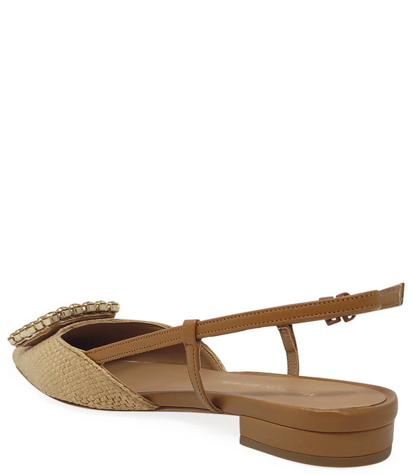 Pointed-toe slingback flat with low heel, adjustable ankle strap, and large decorative jewel embellishment on the toe. Features mixed material textures and an open heel design.