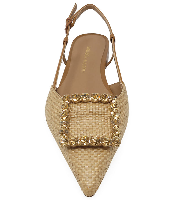 Pointed-toe slingback flat with low heel, adjustable ankle strap, and large decorative jewel embellishment on the toe. Features mixed material textures and an open heel design.
