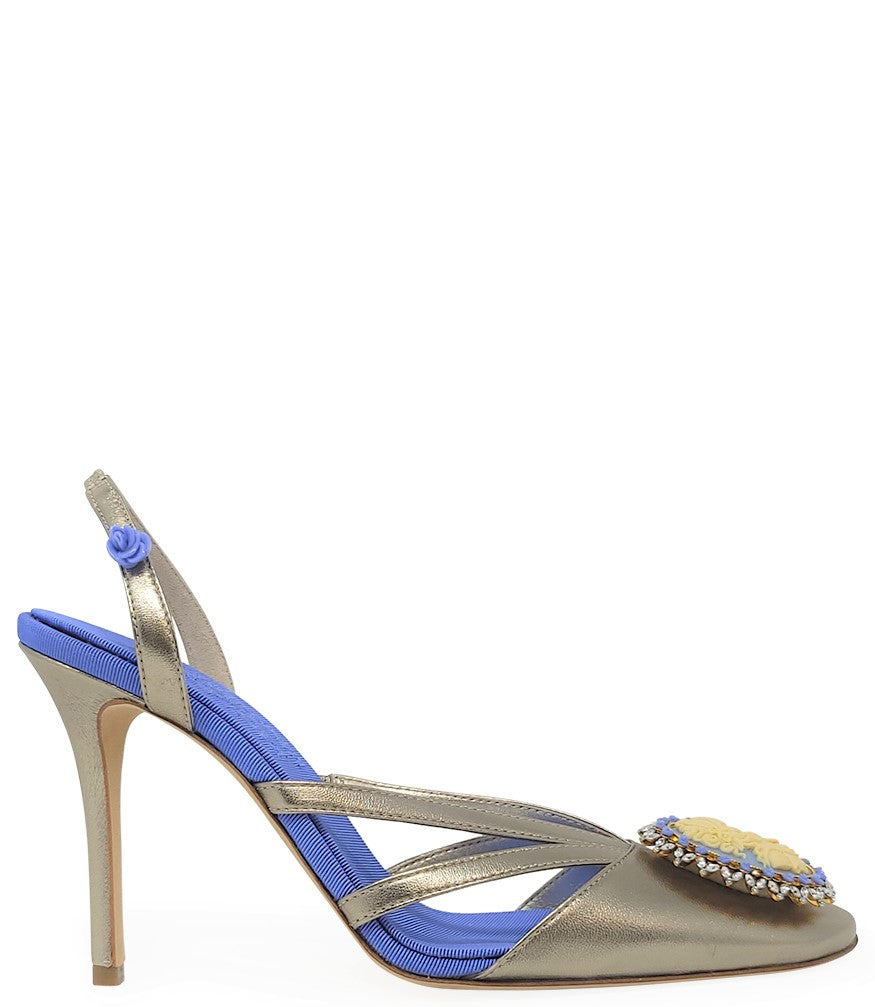 Handcrafted high-heel slingback sandal made in Italy, featuring a strappy upper, sculpted cameo embellishment with crystal detailing on the toe, and a smooth stiletto heel. Padded insole with contrast texture, shown from multiple angles against a clean ba