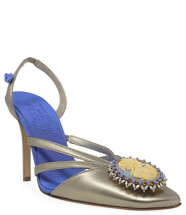 Handcrafted high-heel slingback sandal made in Italy, featuring a strappy upper, sculpted cameo embellishment with crystal detailing on the toe, and a smooth stiletto heel. Padded insole with contrast texture, shown from multiple angles against a clean ba